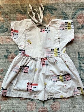 Urbane Baby + KidGirls White Charleston Dress with Pink & Yellow Building Print